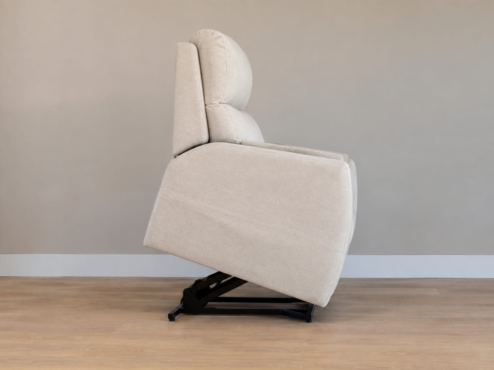A very close view of the top outer corner of an upholstered sofa arm where the cloth turns through ninety degrees, with the tailored seam running down the corner