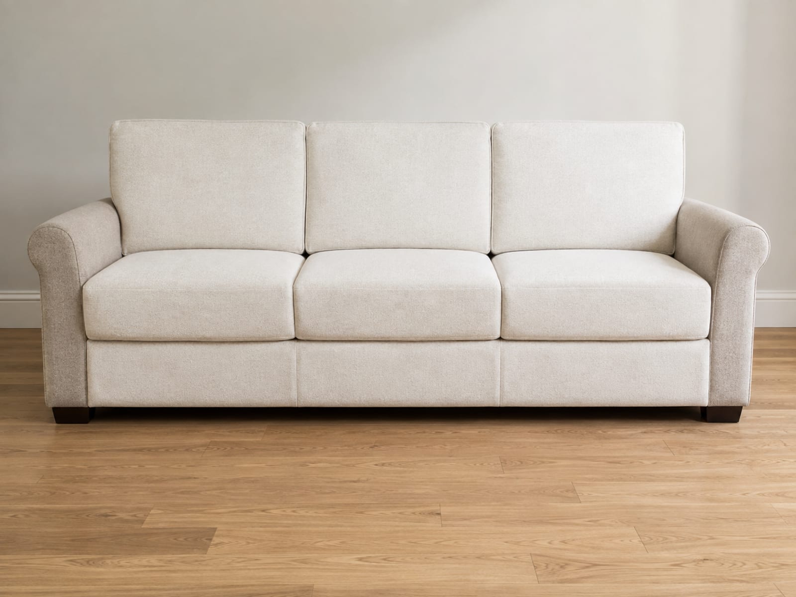 A three-seat sofa with six separate fitted covers on it, one over each seat cushion and each back cushion, showing five join lines across the front